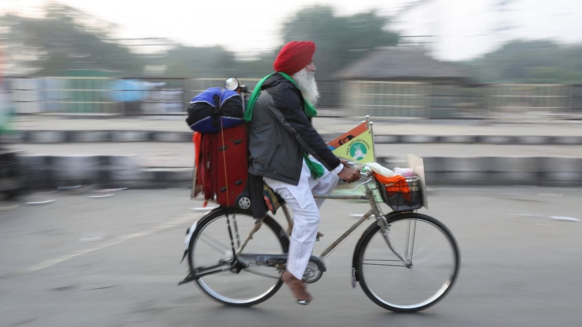 A farmer cycles back home from the protest site at Ghazipur in New Delhi. Credit: Reuters Photo