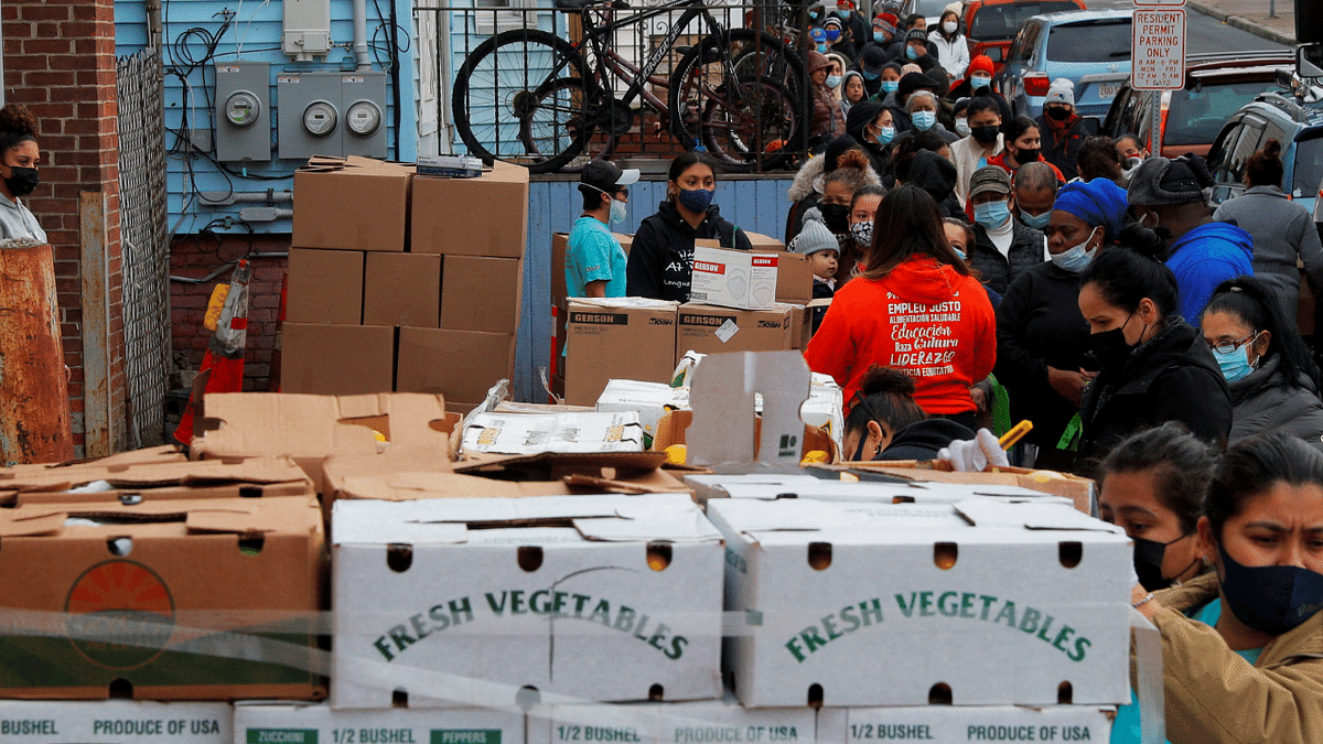 Residents receive free groceries at a food pantry run by a social service organization called La Colaborativa, amid coronavirus, in Chelsea, Massachusetts, US. Credit: Reuters Photo