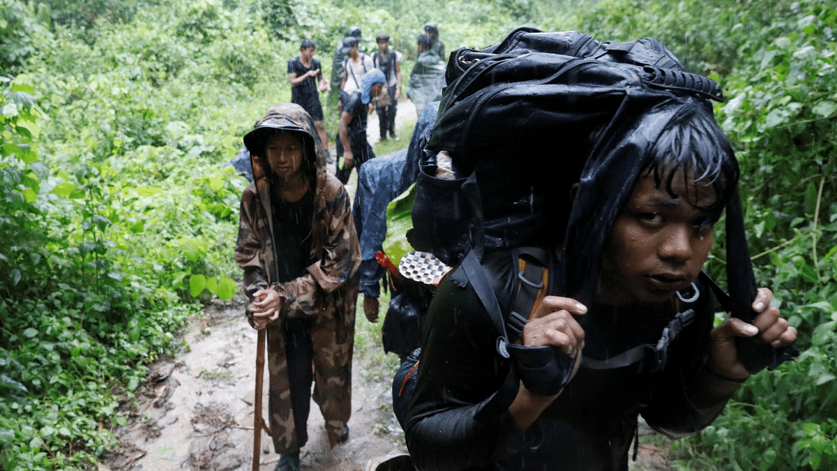 Members of the People's Defence Force (PDF) hike at a training camp in an area controlled by ethnic Karen rebels, Karen State, Myanmar. Credit: Reuters Photo