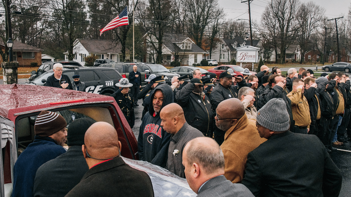 The casket of corrections officer Robert Daniel is placed in a hearse at the Brown Funeral Home on December 18, 2021 in Mayfield, Kentucky. Officer Daniel was killed on December 10 while directing workers and inmates, under his care, to safety during last week's tornado devastation at the candle factory in Mayfield. Credit: AFP Photo