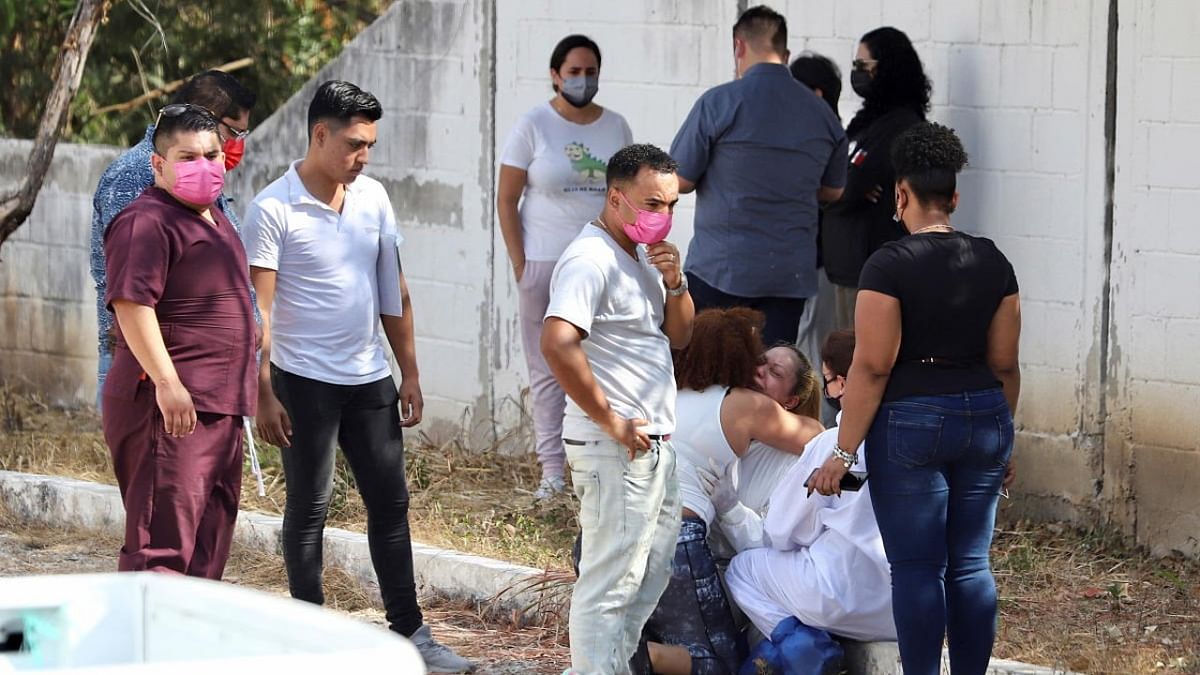Relatives of Dominican cousins Juan Alberto Soto Castillo and Juniel Mordan, who died in a truck accident along Guatemalan migrants in southern Mexico, react after recognizing the bodies at the morgue in Tuxtla Gutierrez, Chiapas. Credit: Reuters photo