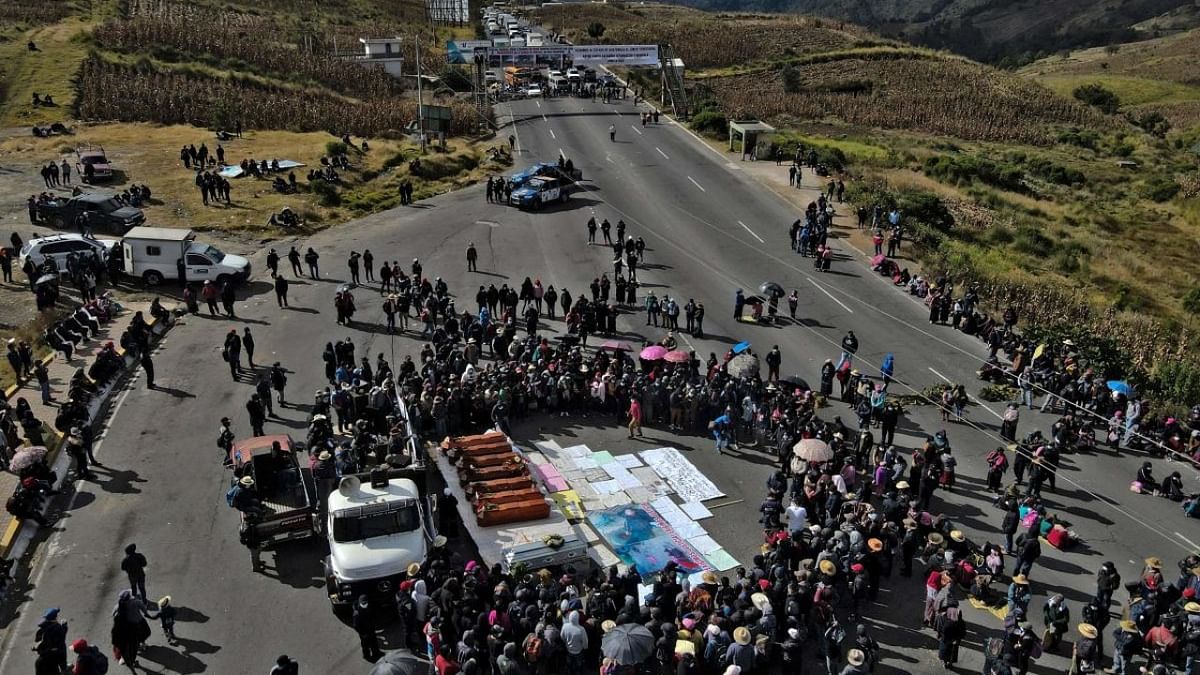 Aerial view of seven coffins of people killed in the village of Chiquix, during a ceremony in Santa Catarina Ixtahuacan, Guatemala. Credit: AFP Photo