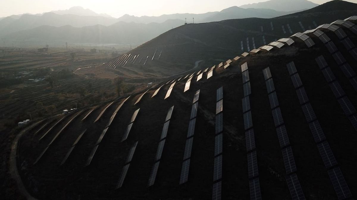This photo taken on October 23, 2021 shows solar panels on hillsides at Huangjiao village in Baoding in China's northern Hebei province. Credit: AFP Photo
