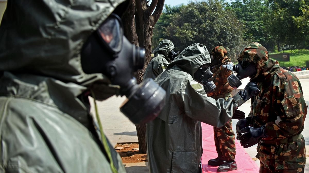 NDRF personnel wear protective gear and gas masks, during a joint mock drill simulating rescue and relief efforts in the event of emergency of CBRN (Chemical, Biological, Radiological, Nuclear) disasters, in Bengaluru. Credit: Pushkar V/DH Photo