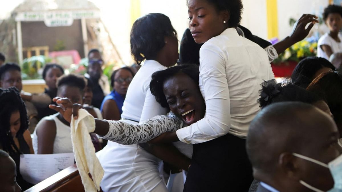 A woman grieves at a mass funeral for victims of a fuel truck explosion, in Cap Haitien, Haiti. Credit: Reuters photo