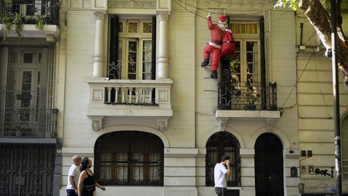 A Santa Claus dummy is seen hanging from a house in Buenos Aires. Credit: AFP Photo
