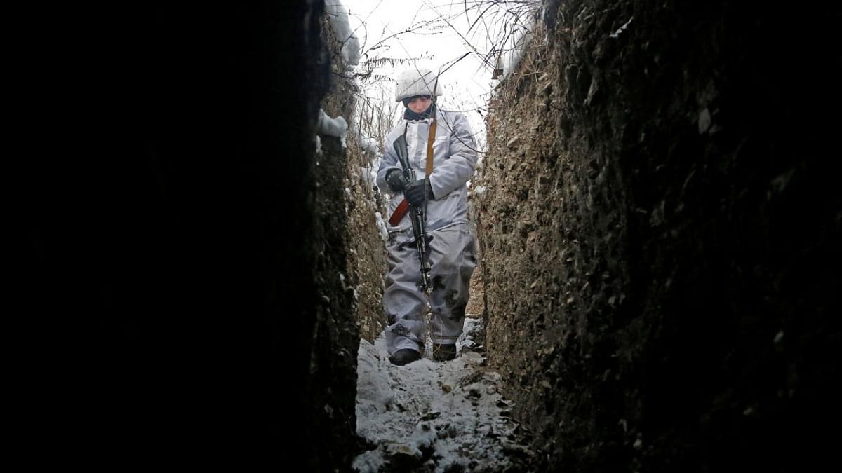A militant of the self-proclaimed Luhansk People's Republic walks in a trench at a fighting position on the line of separation from the Ukrainian armed forces near the settlement of Frunze in Luhansk Region. Credit: Reuters photo