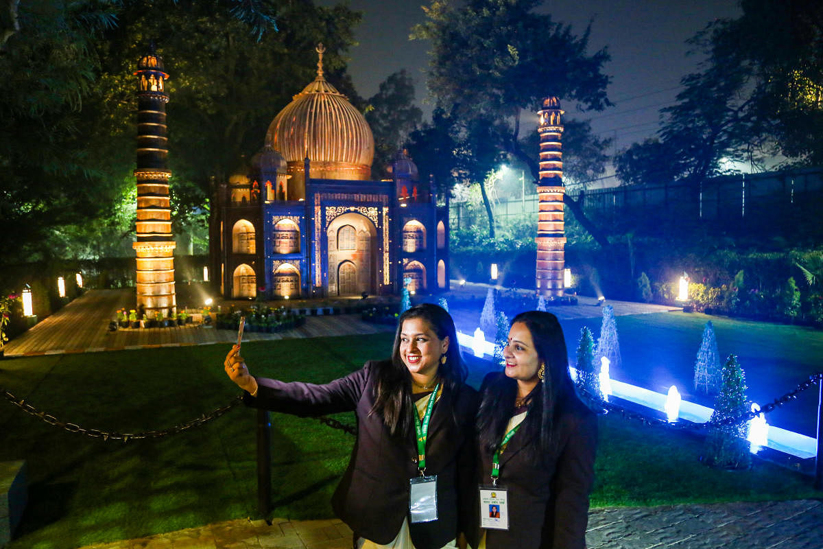 Women take a selfie in front of a replica of Taj Mahal at newly inaugurated park in New Delhi. Credit: PTI Photo