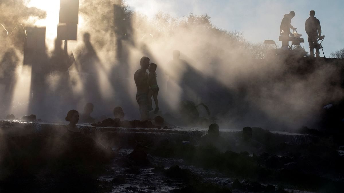 A man holds up a child as bathers soak in the hot water of natural springs in Kibbutz Merom Golan, located in the Israeli-occupied Golan Heights. Credit: Reuters Photo
