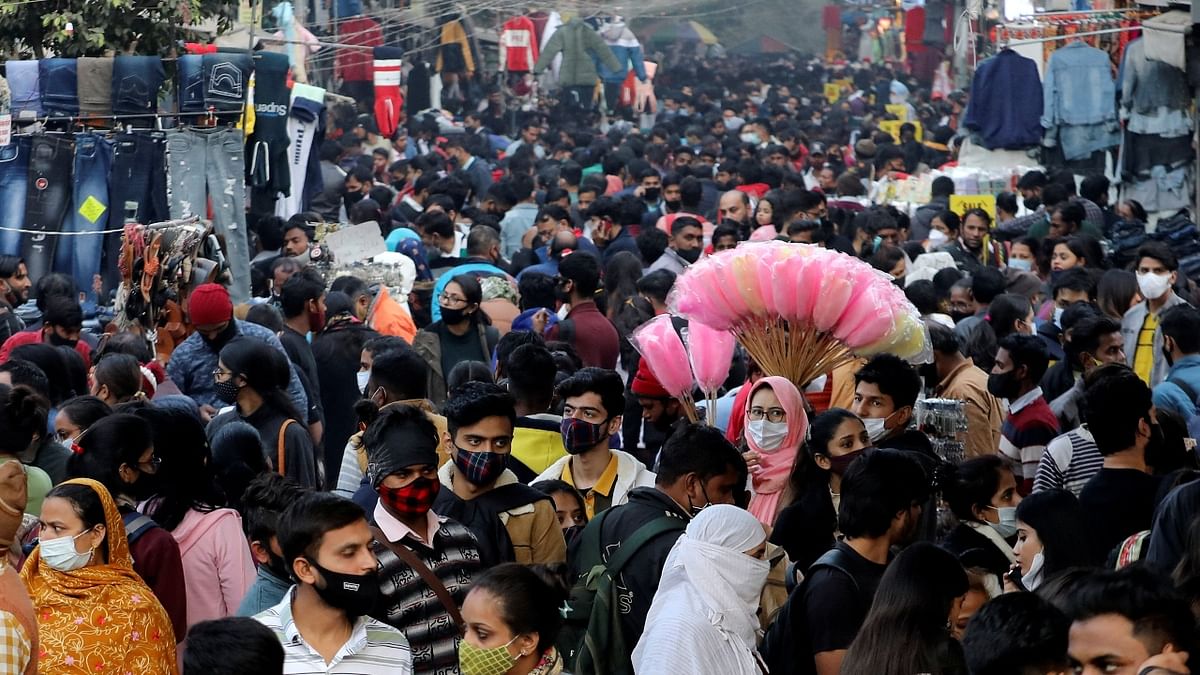People shop at a crowded market ahead of Christmas, during the ongoing coronavirus disease (COVID-19) pandemic, in New Delhi. Credit: Reuters Photo