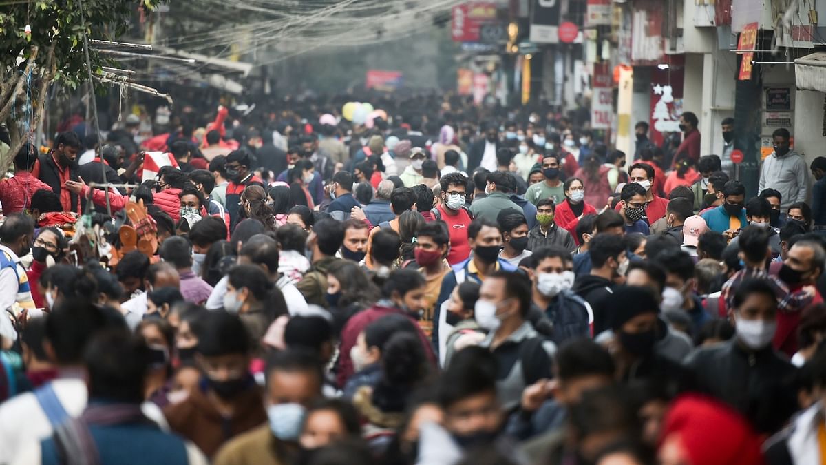 Locals in Delhi-NCR are visiting markets in large numbers for shopping this year unlike in 2020 when they could not step out due to the COVID-19 pandemic. In this photo, Sea of people are seen at the Sarojini Nagar market on Christmas. Credit: PTI Photo