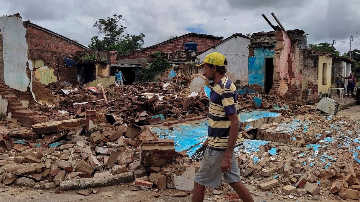 A man walks by houses destroyed by a flood in Itambe after weeks of heavy rains in the Brazilian state of Bahia. Credit: AFP Photo