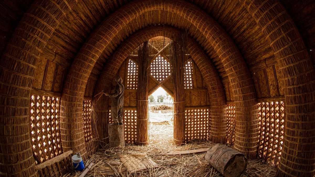 An Iraqi craftsman works on the construction of a traditional guest house (Mudhif), in front of the museum of the southern city of Basra. Credit: AFP Photo