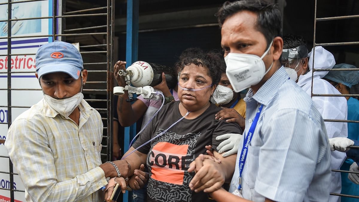 Health workers shift patients from Vijay Vallabh Covid care hospital after a fire in Virar West on the outskirts of Mumbai. Maharashtra was one of the states that was hugely impacted by the second Covid wave that caused unprecedented devastation throughout the state. Credit: PTI Photo/Kunal Patil