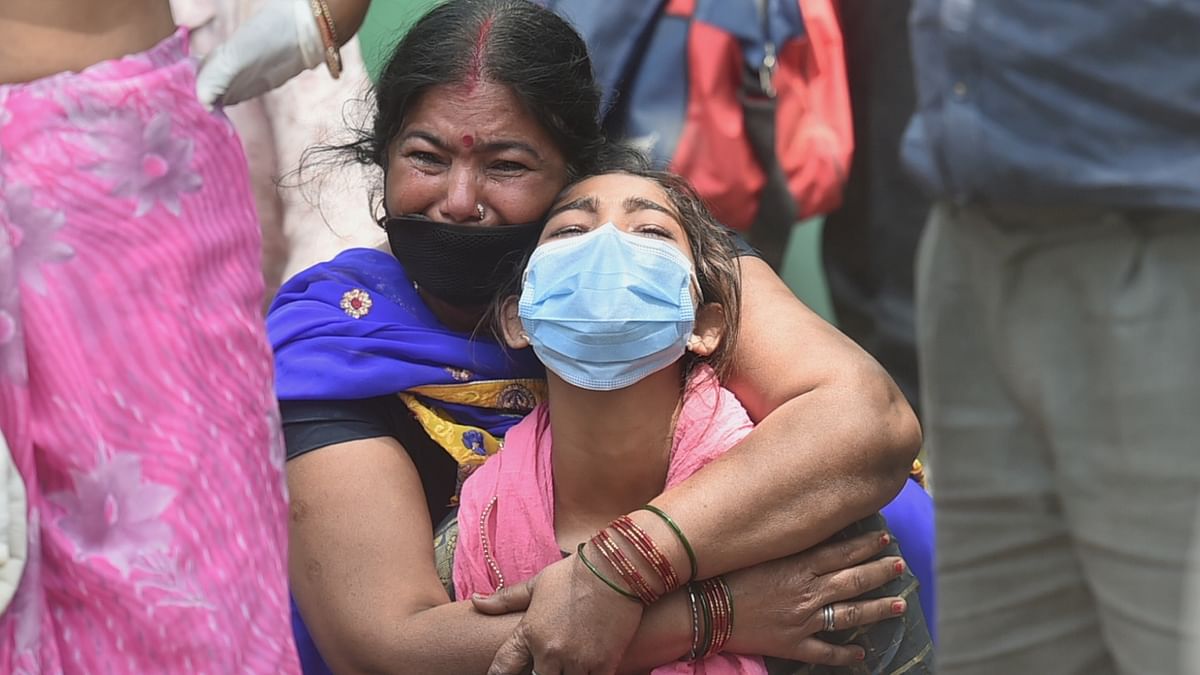 Relatives react during the cremation of a Covid-19 victim at Bhairav Ghat Hindu Crematory, as coronavirus cases had surged, in Kanpur. Credit: PTI Photo/Arun Sharma