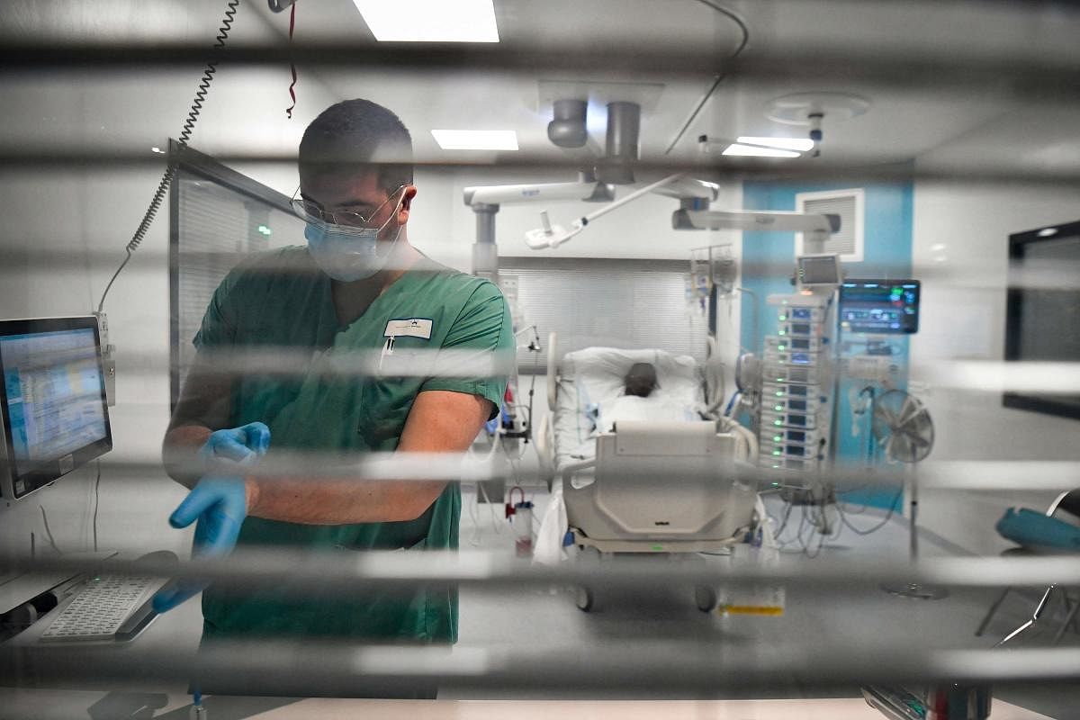 A nurse tends to a Covid-19 patient at the intensive care unit (ICU) of the Delafontaine AP-HP hospital in Saint-Denis, outside Paris. Credit: AFP Photo