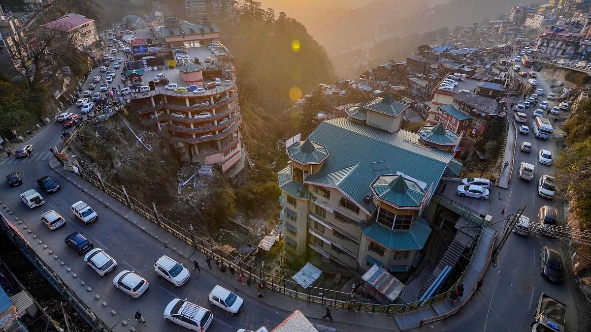 Vehicles move slowly during a traffic jam, ahead of New Year 2022 celebrations in Shimla. Credit: PTI Photo