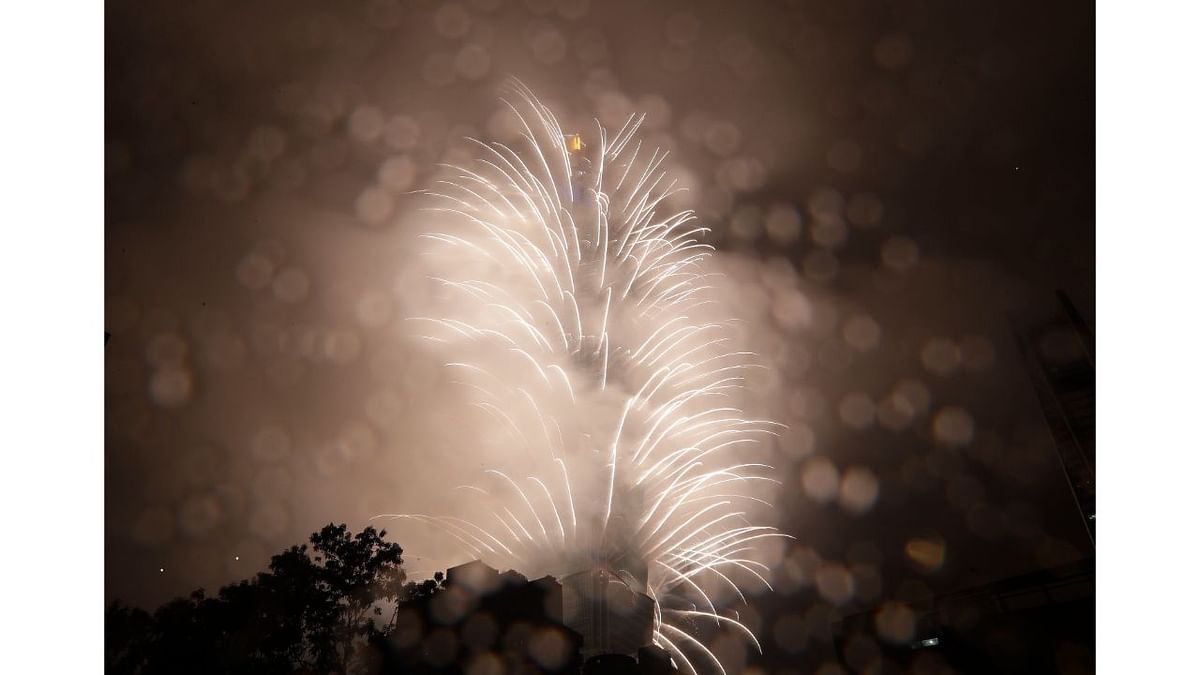 Fireworks explode from the Taipei 101 building in rainy weather during the New Year's celebrations in Taipei, Taiwan. Credit: AP Photo