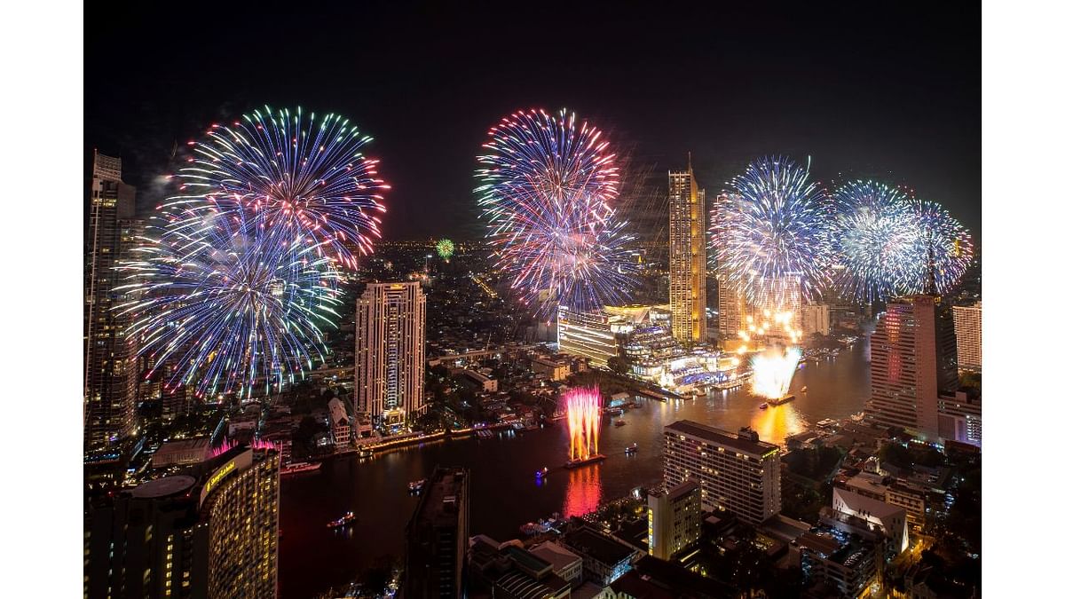 Fireworks explode over the Chao Phraya River during New Year celebrations in Bangkok, Thailand. Credit: AP Photo