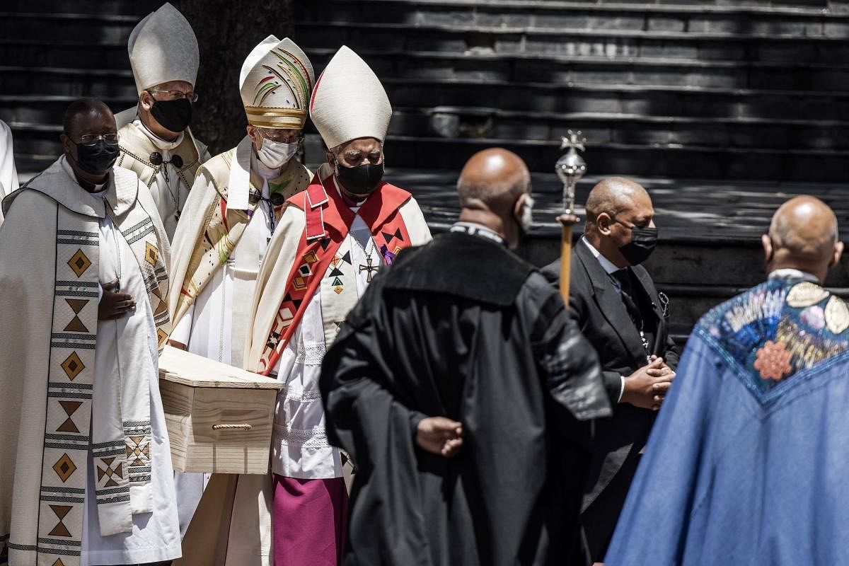 Pallbearers carry the coffin of South African anti-Apartheid icon Archbishop Desmond Tutu to the hearse after the requiem mass of Tutu at St. George’s Cathedral in Cape Town. Credit: AFP Photo
