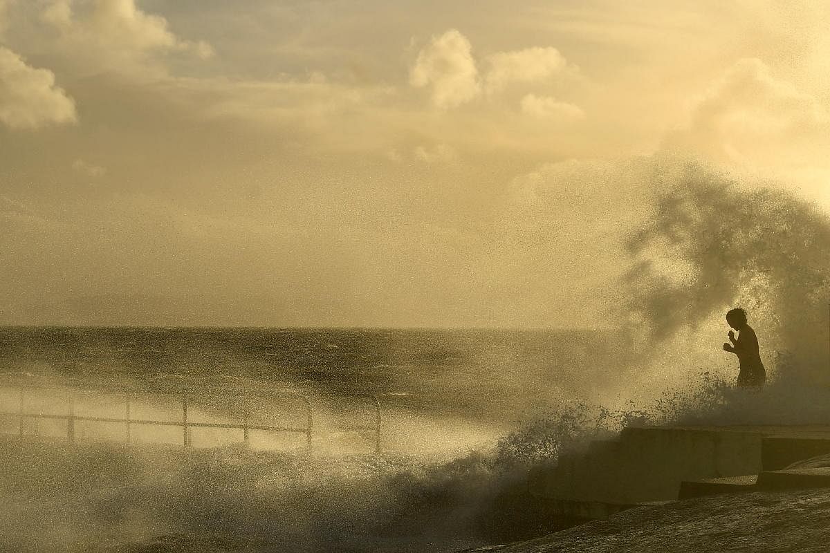 A woman is engulfed in waves before participating in a traditional New Year's Day swim at Blackrock diving tower during severe wind, in Galway, Ireland. Credit: Reuters Photo