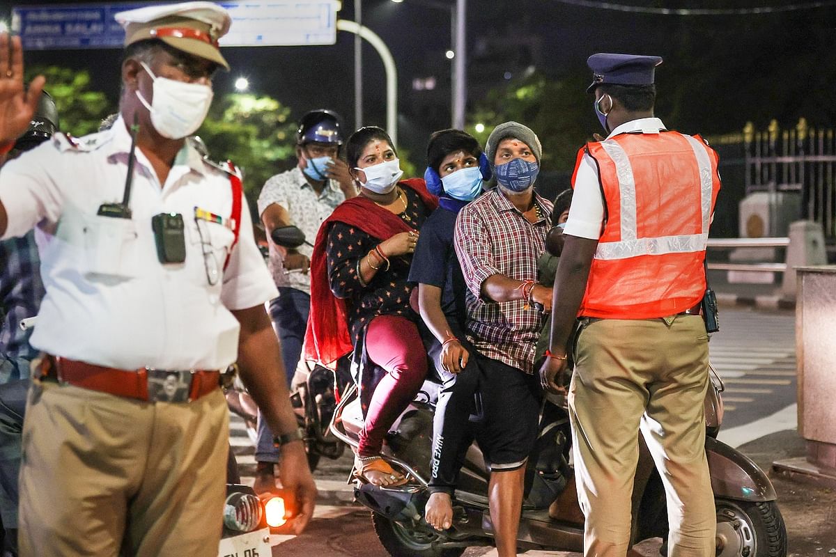 Policemen stop people during the night curfew between 10 pm to 5 am imposed by the Tamil Nadu government to curb the spread of Covid-19. Credit: PTI Photo