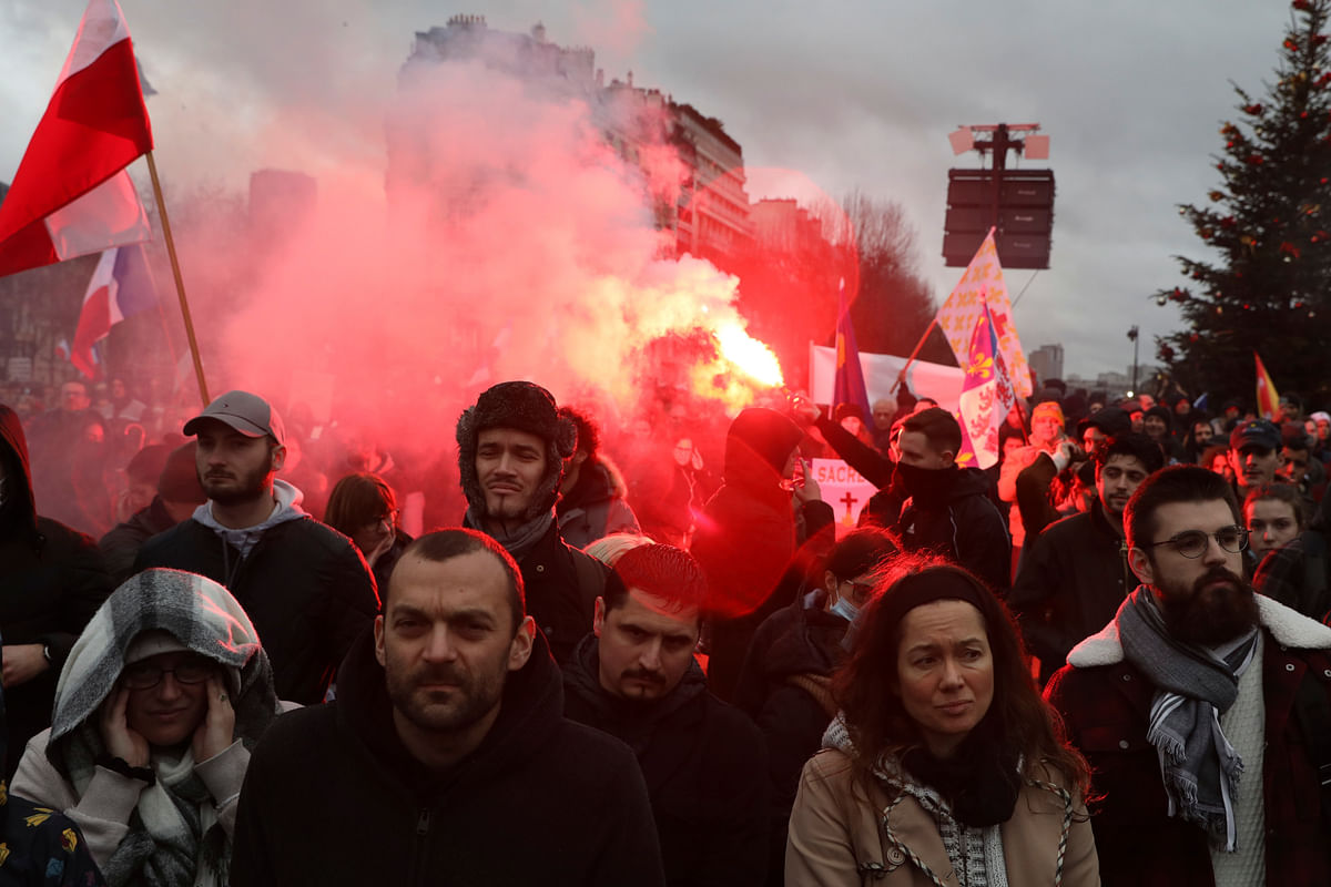 Demonstrators, in opposition to vaccine pass and vaccinations to protect against Covid-19 gather during a rally in Paris, France. Credit: AP Photo