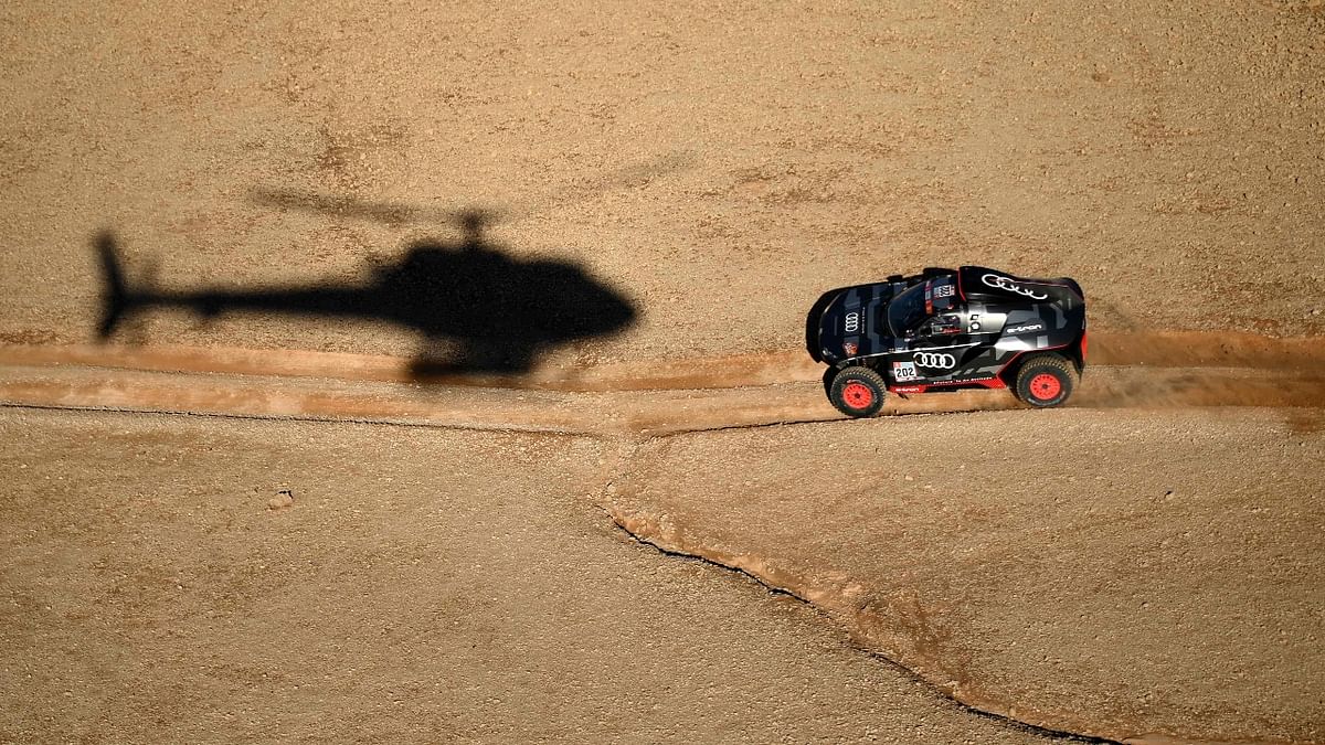 Audi's electric Spanish driver Carlos Sainz and co-driver Lucas Cruz of Spain compete during the Stage 5 of the Dakar 2022 around Riyadh in Saudi Arabia. Credit: AFP Photo