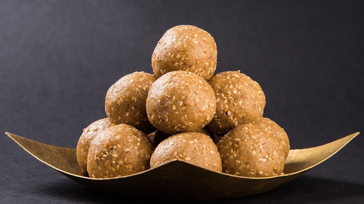 Til Ladoo: A staple Makar Sankrati recipe, Til Ladoo is made with roasted sesame seeds perfectly set in jaggery syrup. This perfect aromatic dish is rich in taste and is good for health. Credit: Getty Images