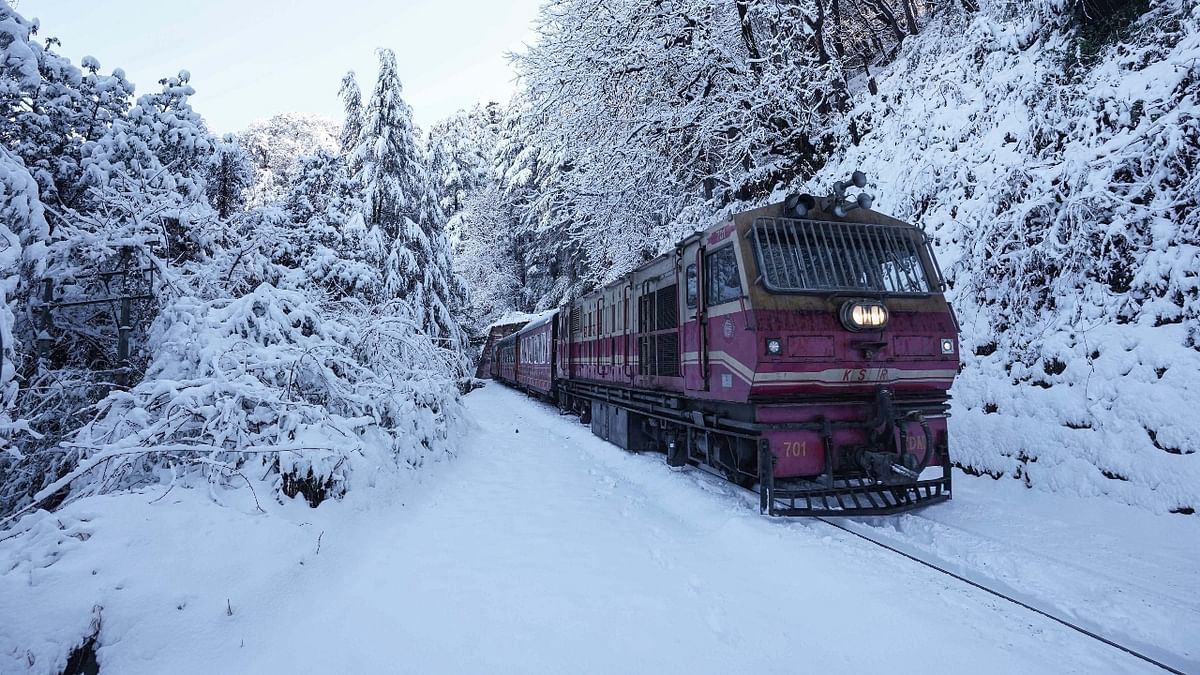 A toy train runs on Kalka-Shimla heritage rail track covered in snow after heavy snowfall in Shimla. Credit: PTI Photo