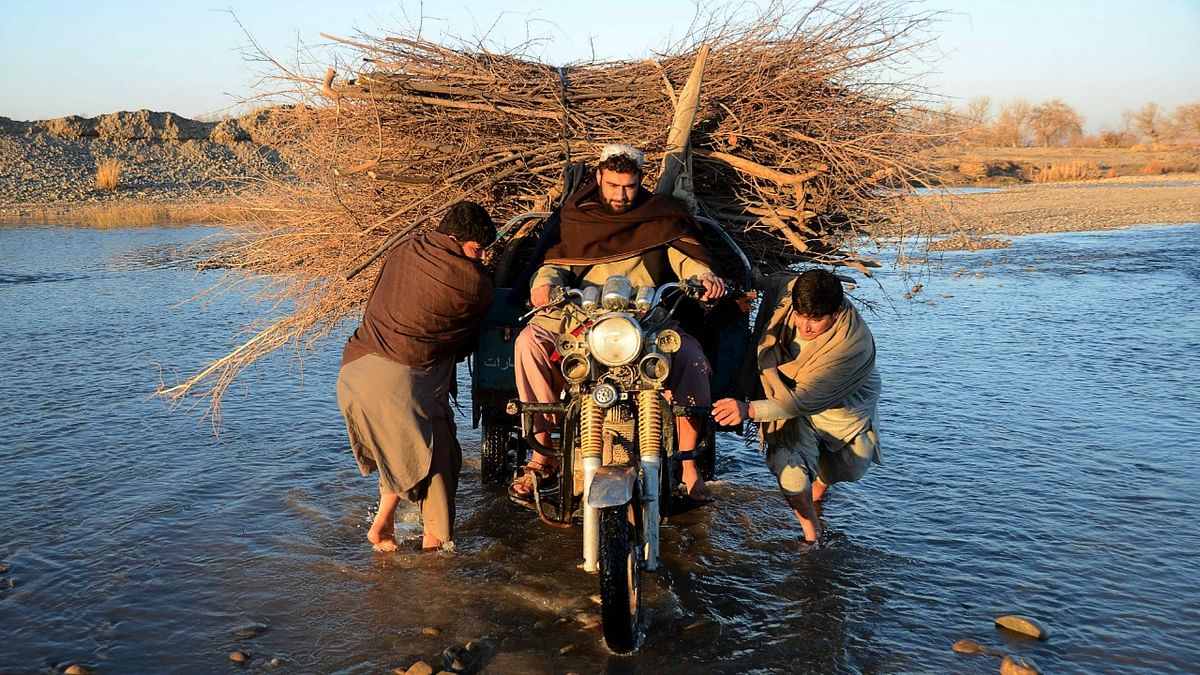 Men cross the Arghandab river on their three-wheeler laden with shrubs on the outskirts of Kandahar. Credit: AFP Photo