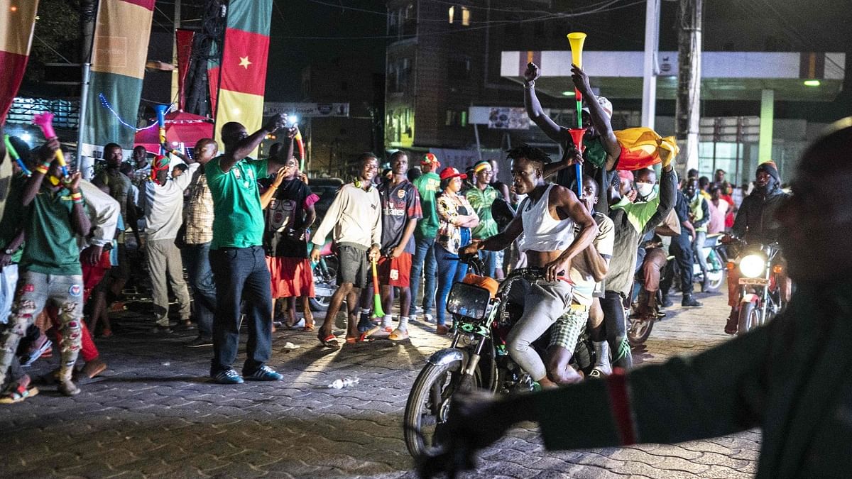 Cameroon's fans celebrate in Douala, western Cameroon, after Cameroon won the Africa Cup of Nations (AFCON) 2021 round of 16 football match between Cameroon and Comoros. Credit: AFP Photo