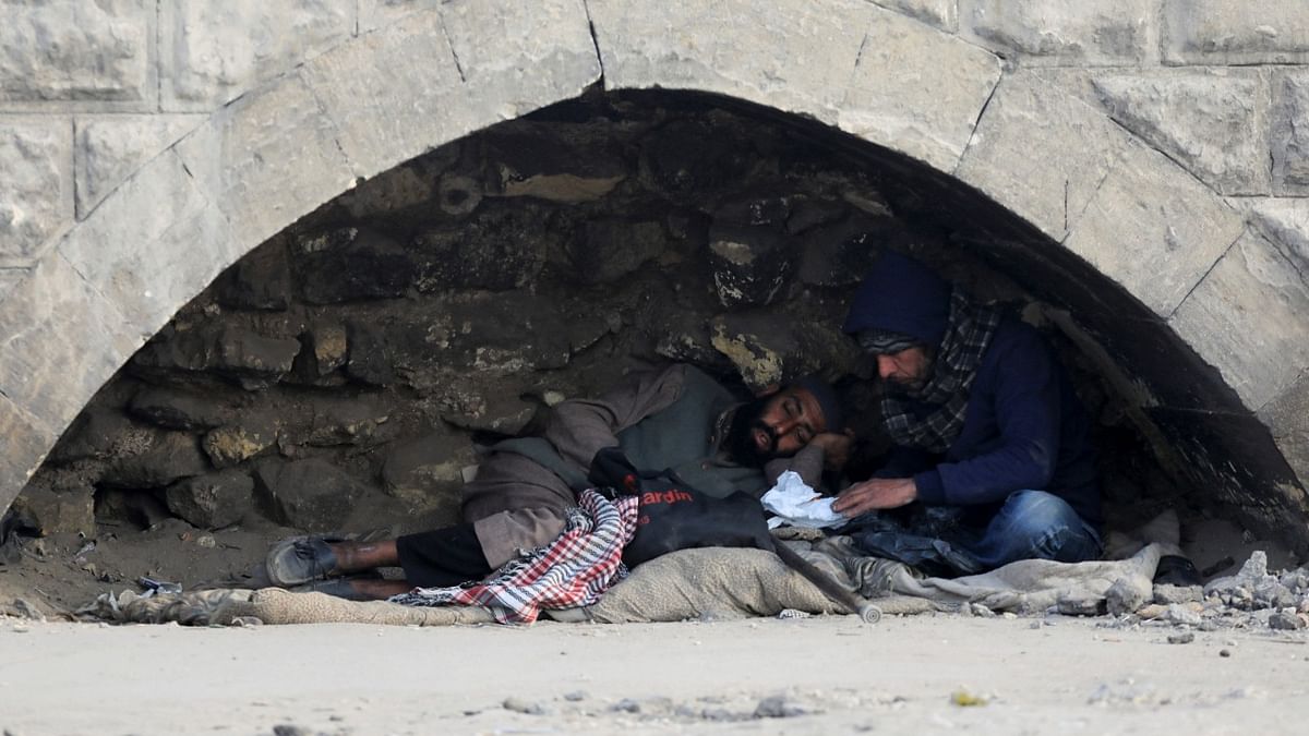 Homeless Egyptians rest next to a wall in Cairo, Egypt. Credit: Reuters Photo