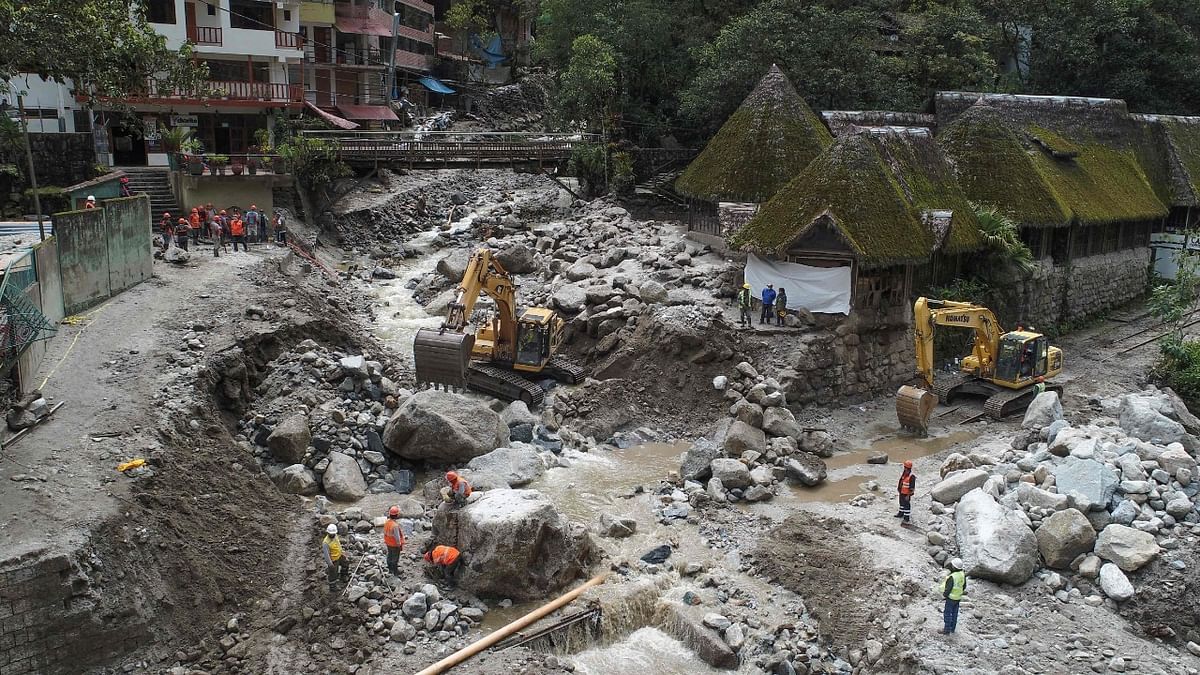 Workers clean up the debris brought by a flash flood caused by season rains at the town of Machu Picchu, Peru. Credit: AFP Photo