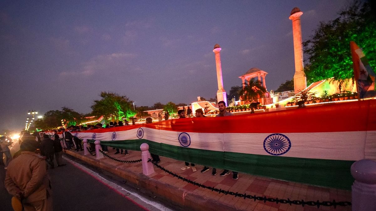 NSUI members hold a 200-meter-long national flag on the eve of Republic Day 2022 at Amar Jawan Jyoti memorial in Jaipur. Credit: PTI Photo