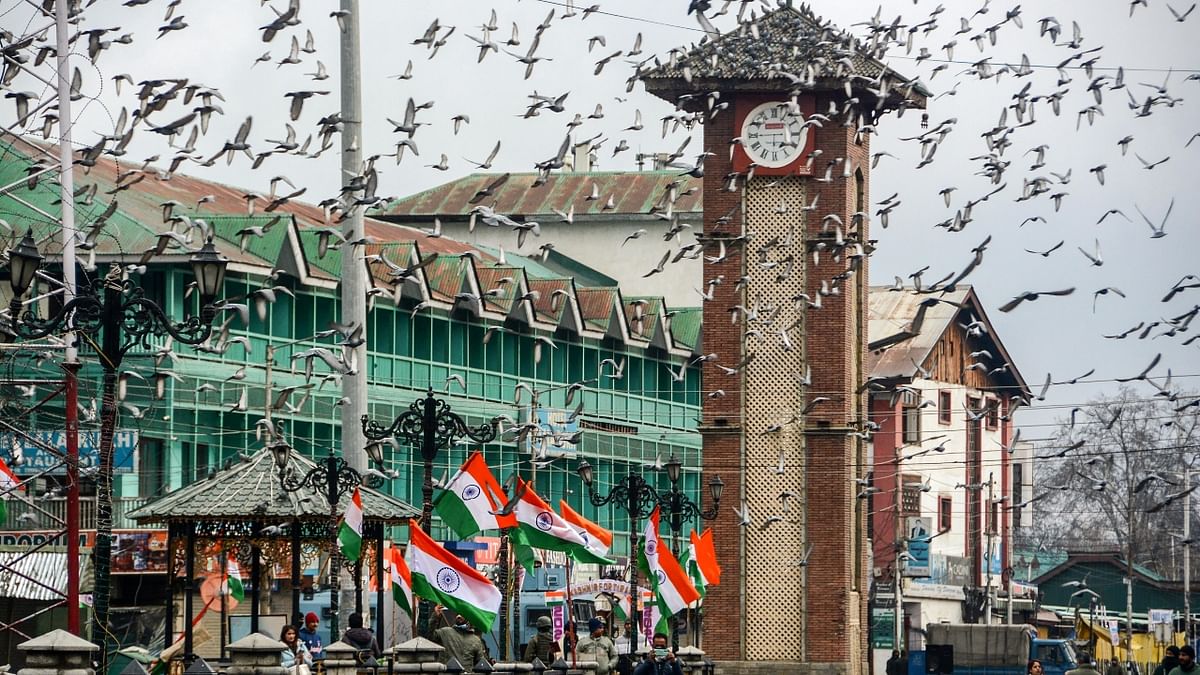 Pigeons fly past the historical Ghanta Ghar at Lal Chowk during the 73rd Republic Day celebrations in Srinagar. Credit: PTI Photo