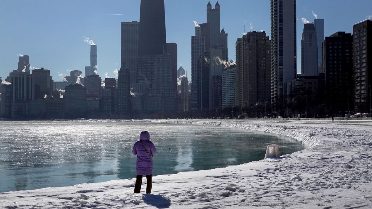 A woman walks along the shore of Lake Michigan as temperatures hang in the single digits in Chicago, Illinois. Credit: AFP Photo