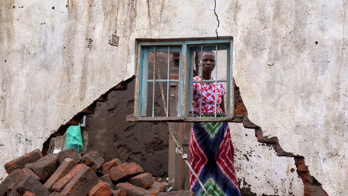 A woman looks on at her house destroyed by tropical storm Ana at Kanjedza village, in Chikwawa district, southern Malawi