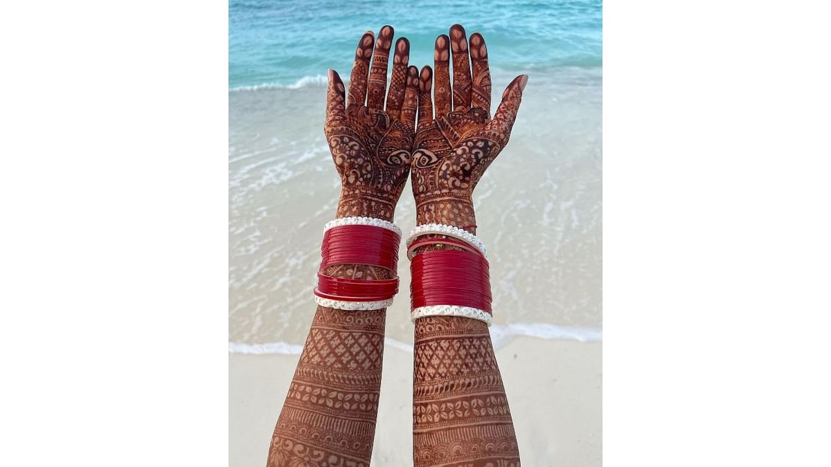 Earlier, Katrina gave a glimpse from her romantic vacation. She posted a photo of her mehendi-clad hands against sea and sand in the background. Credit: Instagram/katrinakaif