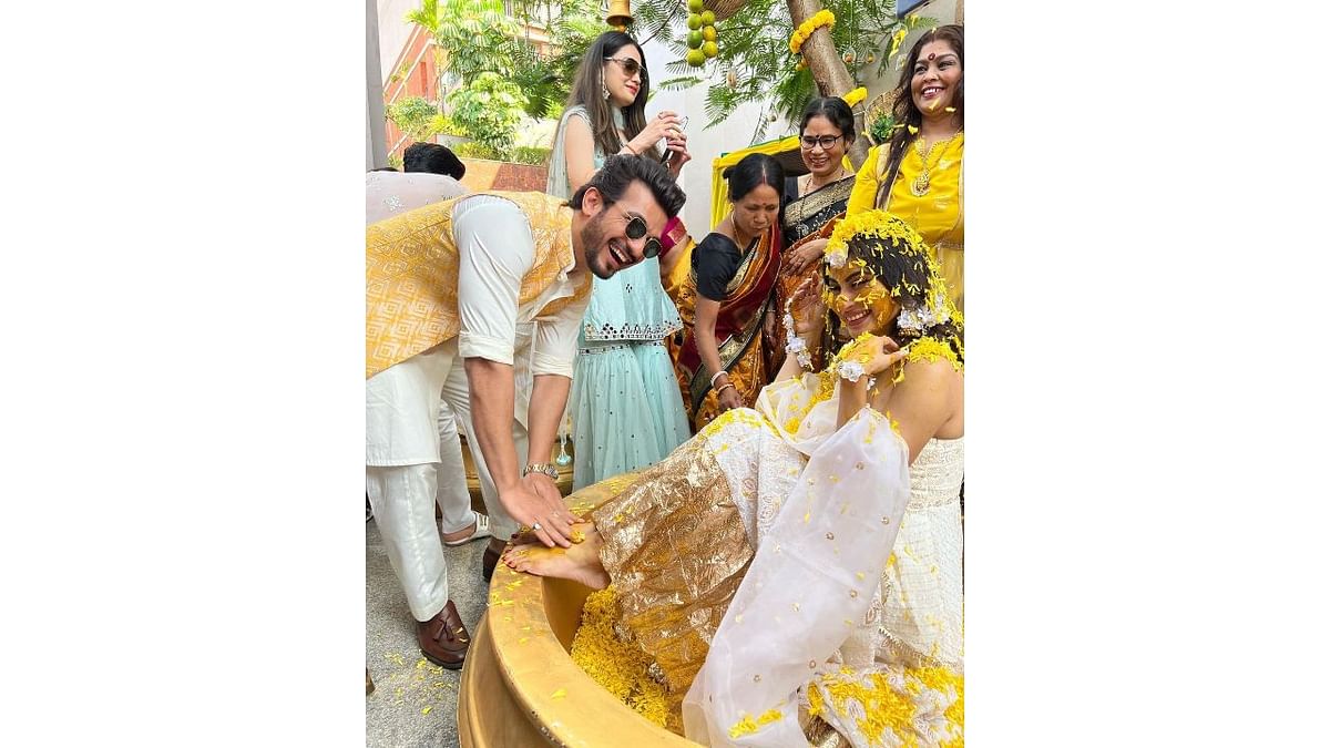 Check out this candid picture of Arjun Bijlani and Mouni Roy from her mehendi ceremony. Credit: Instagram/arjunbijlani