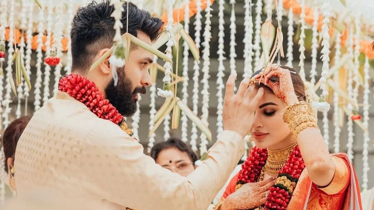 Suraj is seen applying sindoor on Mouni Roy's forehead during their wedding in Goa. Credit: Instagram/nambiar13
