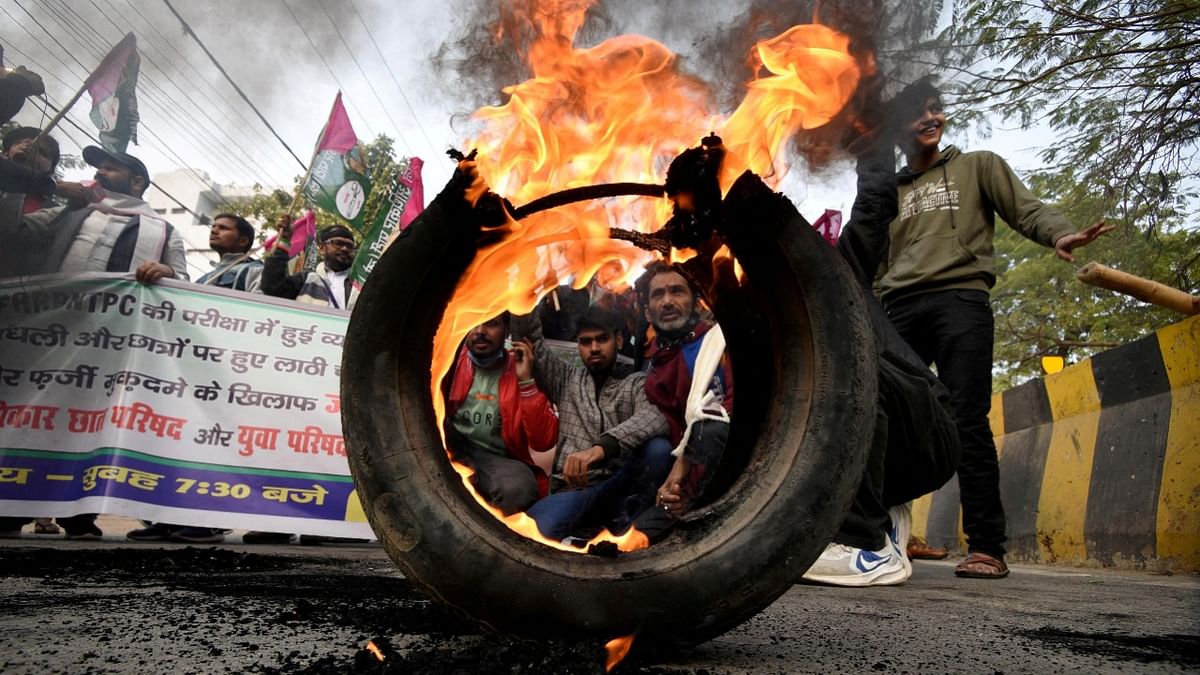 Activists from Jan Adhikar Party burn tyres as they block a road during a strike called by student associations to protest against what they call irregularities in recruitment by the railways department, in Patna, Bihar. Credit: Reuters Photo