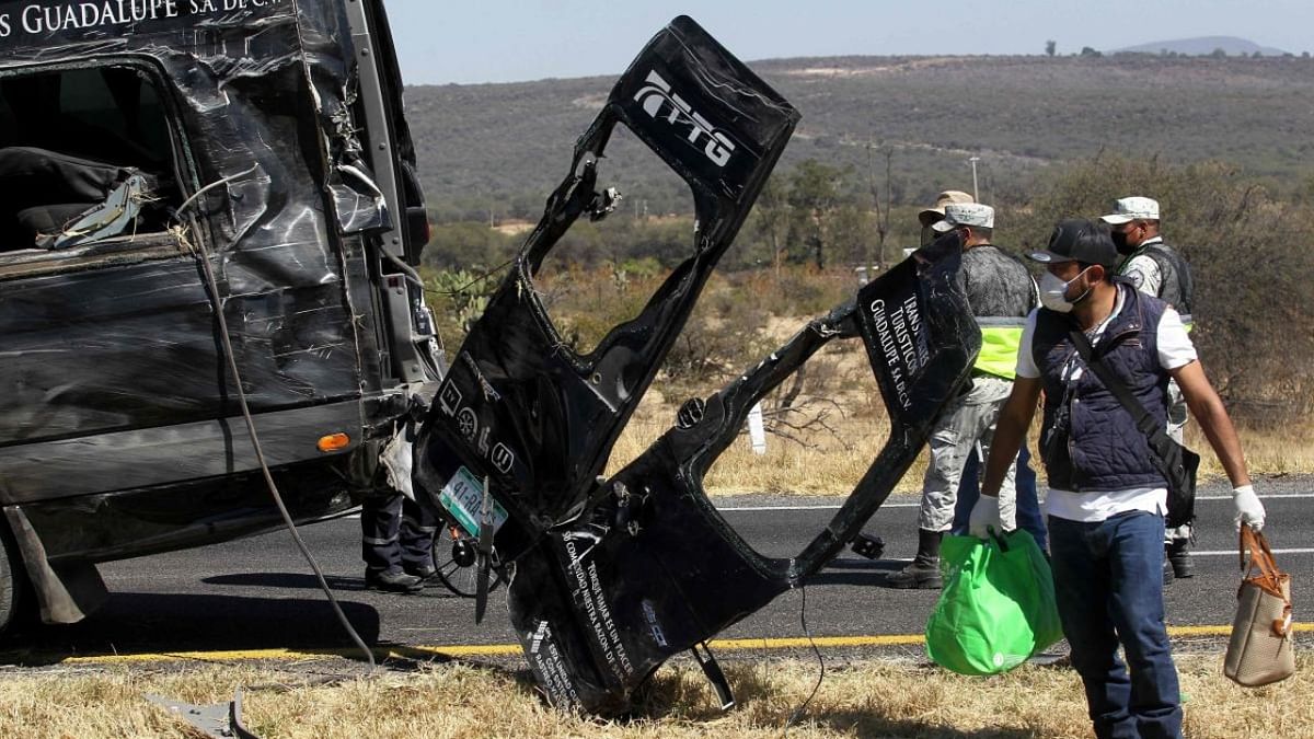 Rescue and forensic teams work at the scene of a road accident in which 12 members of the same family died and 11 other people were injured in Lagos de Moreno, state of Jalisco Mexico. Credit: AFP Photo