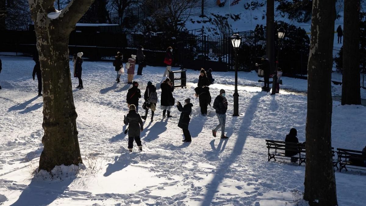 People walk along a snow-covered road in Central Park in New York City. Credit: AFP Photo