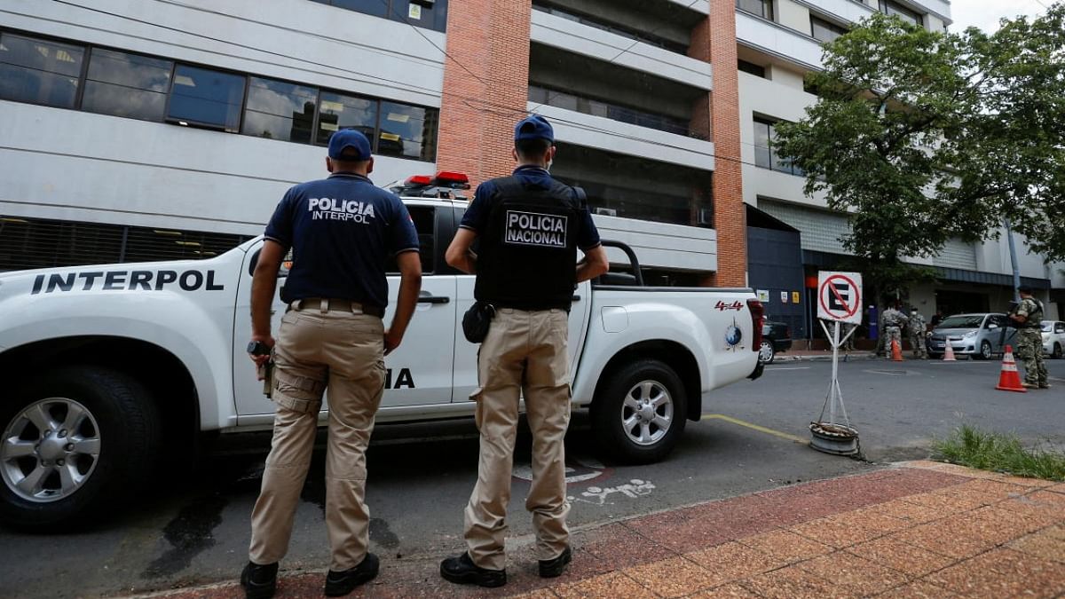 Police officers stand guard outside a hospital where victims of a shooting that occurred at a concert outside the capital are treated, in Asuncion, Paraguay. Credit: Reuters photo