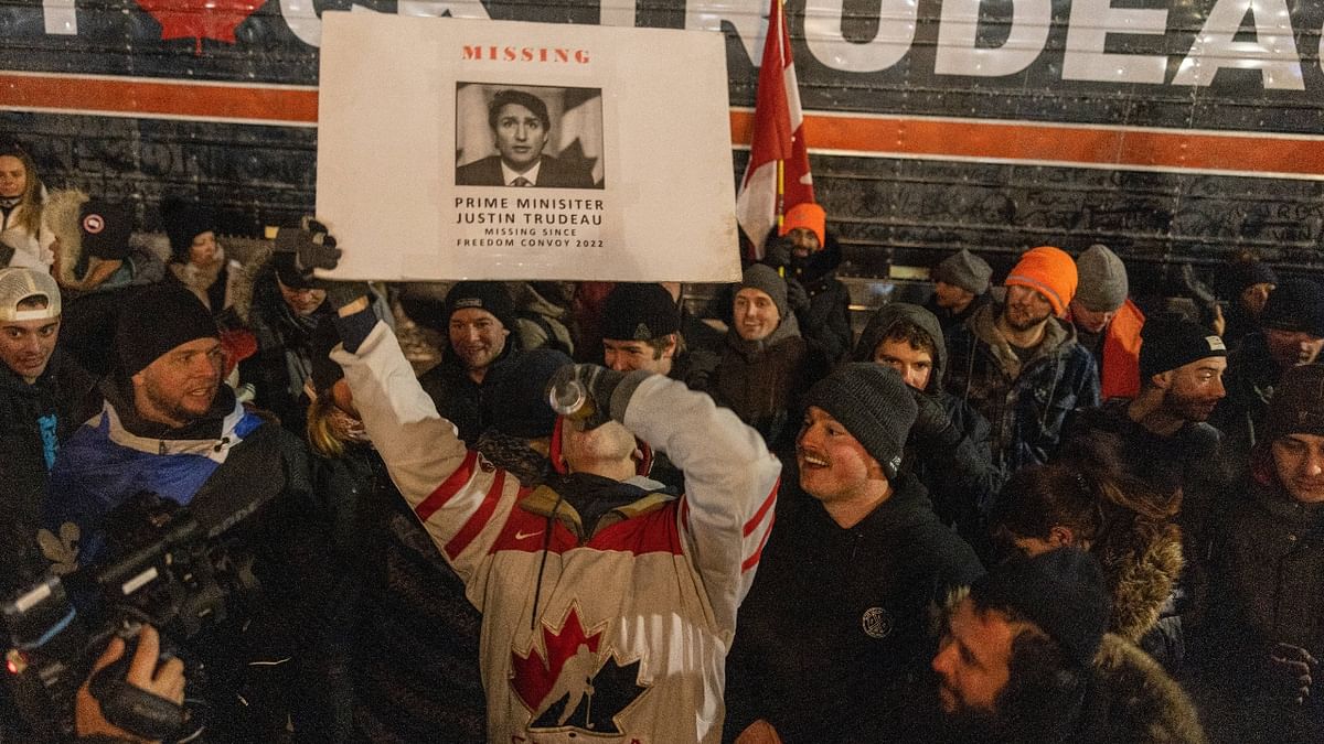 A large number of protestors gathered around the Parliament Hill, waving flags and banners and chanting slogans against PM Justin Trudeau, who is self-isolating after one of his children tested positive for the coronavirus. Credit: AFP Photo