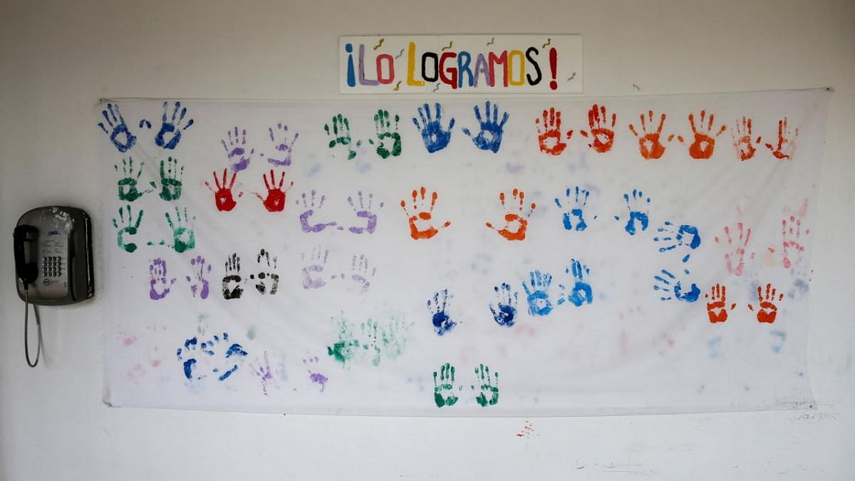 The handprints of patients who survived Covid-19 are shown on a banner below the words