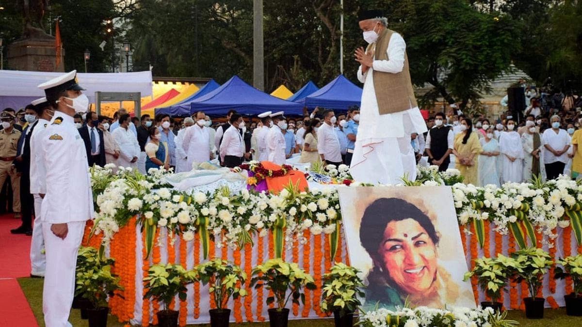 Maharashtra Governor Bhagat Singh Koshyari pays his last respects to legendary singer Lata Mangeshkar during her funeral in Mumbai. Credit: PTI Photo