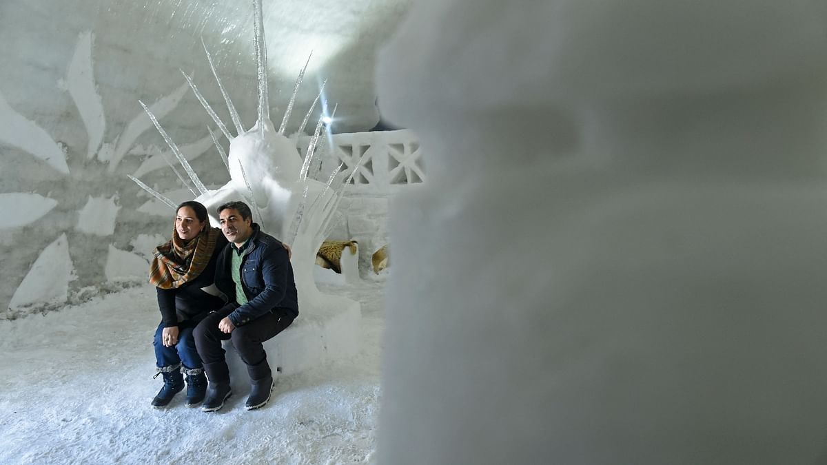 A couple poses inside the igloo cafe in Gulmarg, Srinagar. Credit: AFP Photo