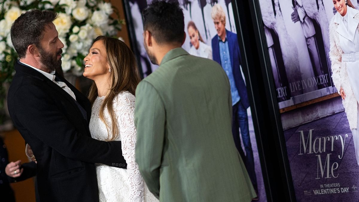 Ben and J Lo share sweet nothings as others look on. Credit: AFP Photo